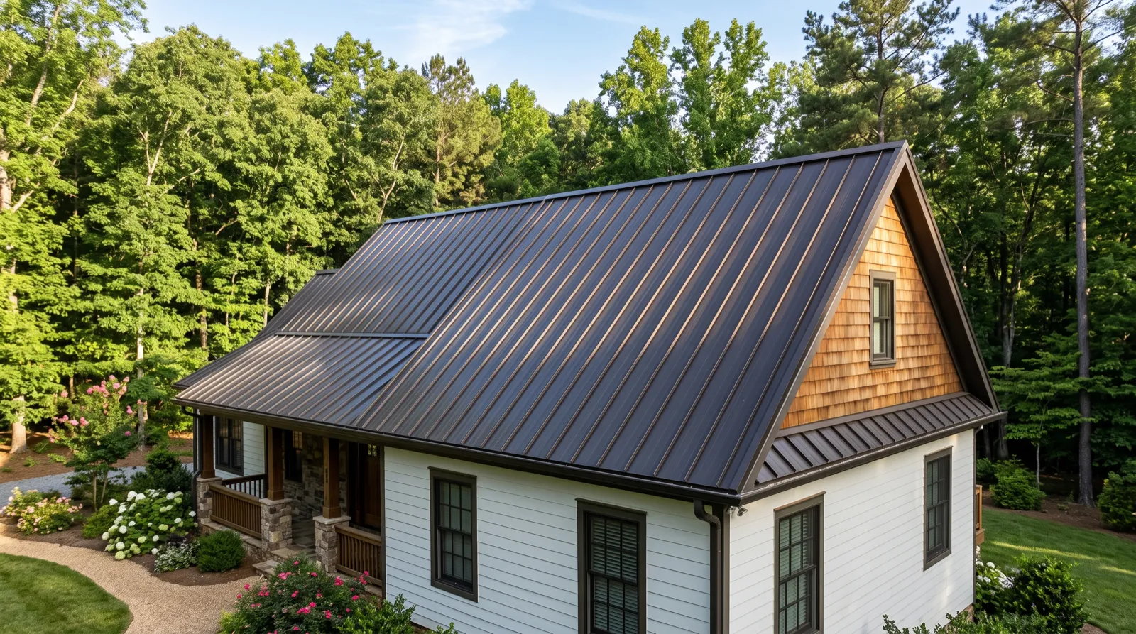 A dark bronze standing seam metal roof with crisp vertical seams running to the ridge